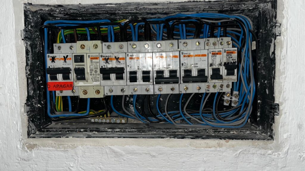 Electricista profesional realizando mantenimiento eléctrico en centro pública concurrencia